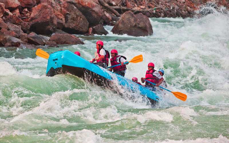 River rafting group in Rishikesh enjoying Grade III rapids